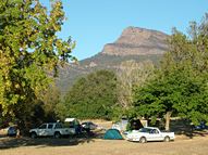 Camping site with shady tree and views of the Grampians and a fire place